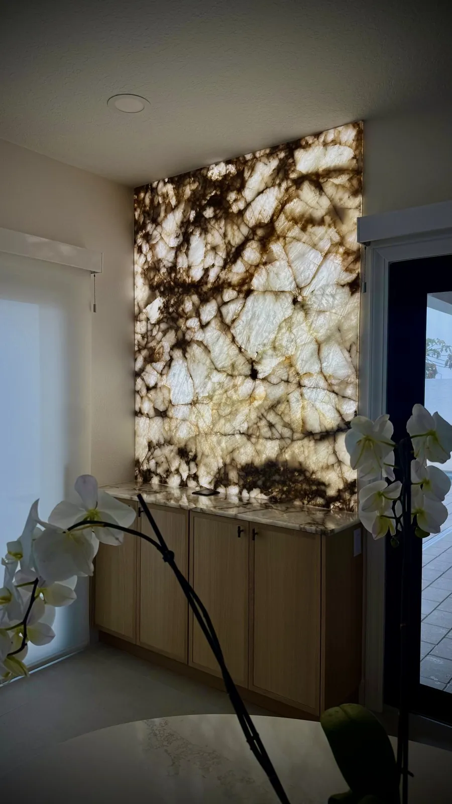 Backlit stone feature wall with custom cabinetry